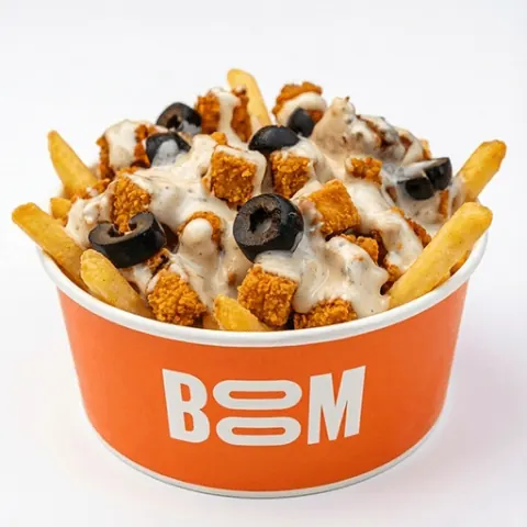 BOOM loaded tender fries in the orange BOOM bowl